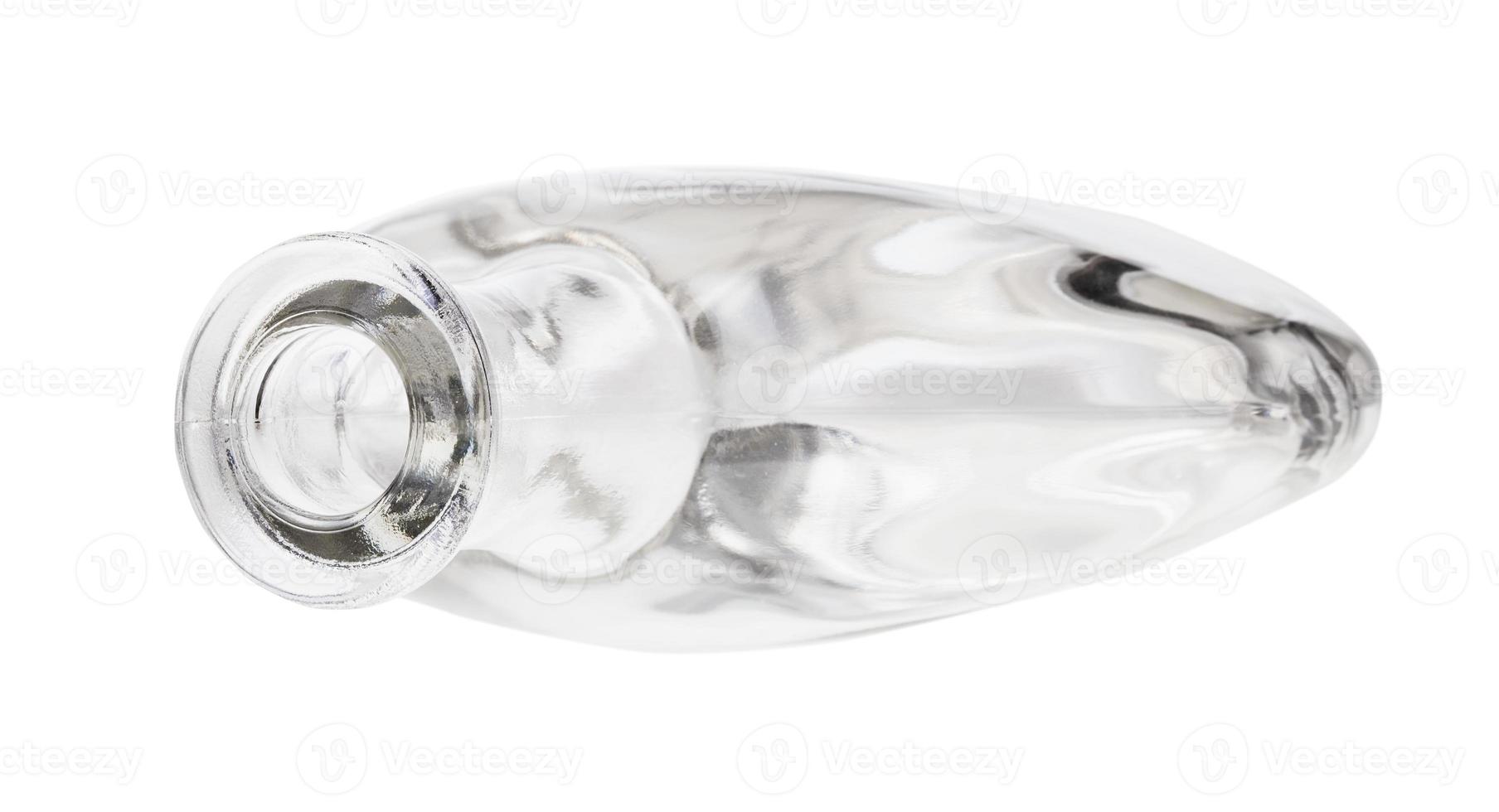 overturned empty clear cognac bottle isolated photo
