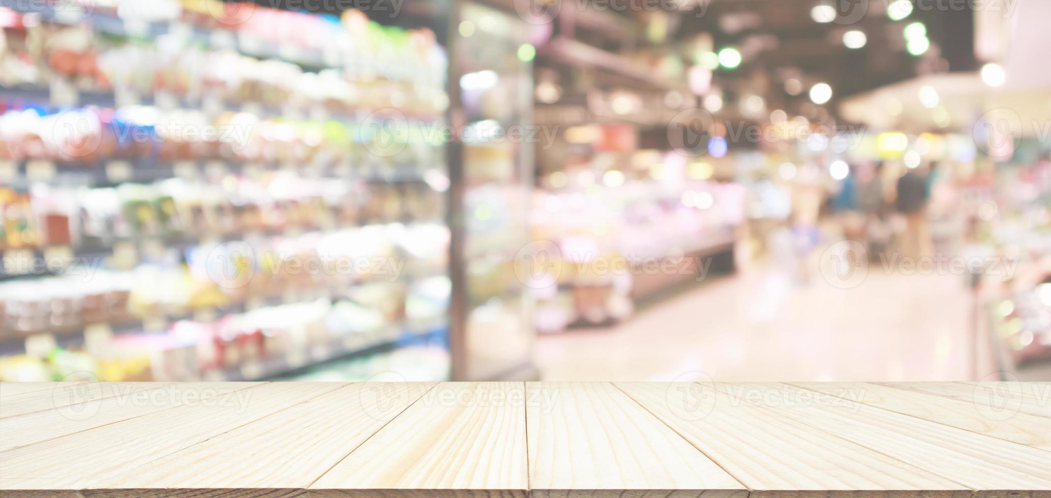 Wood table top with supermarket grocery store blurred defocused background with bokeh light photo