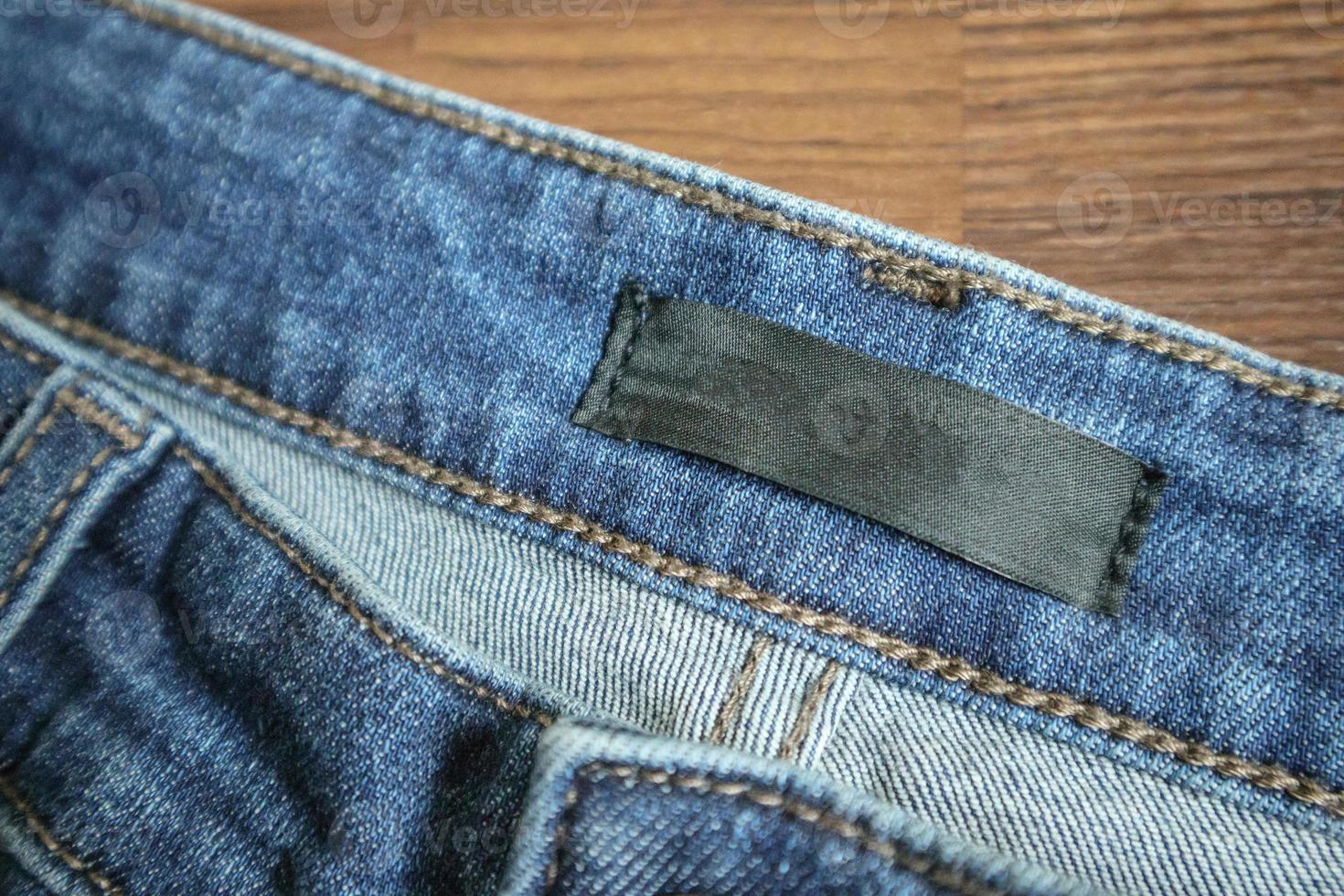 Blue jeans with blank clothing label tag photo
