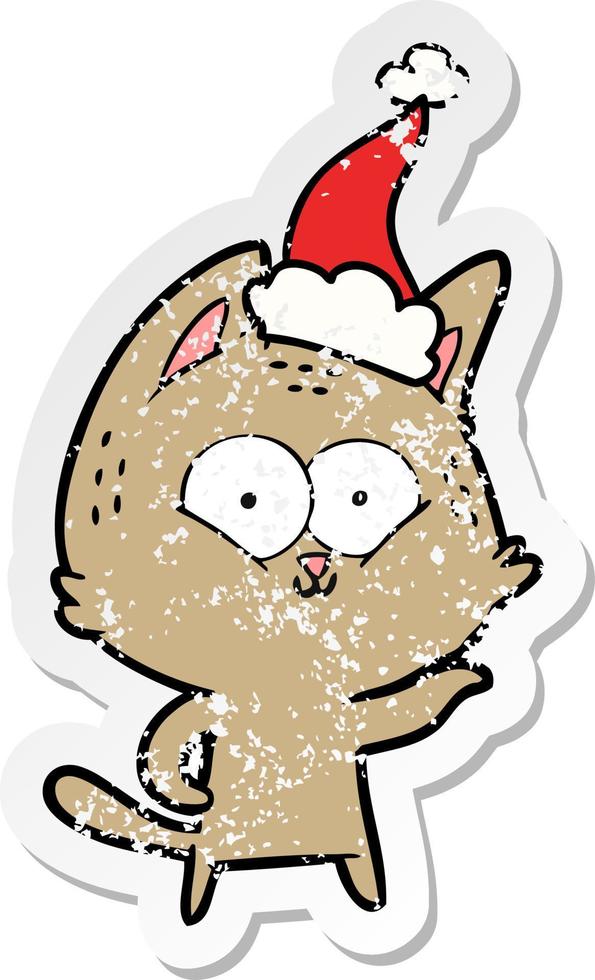 distressed sticker cartoon of a cat wearing santa hat vector