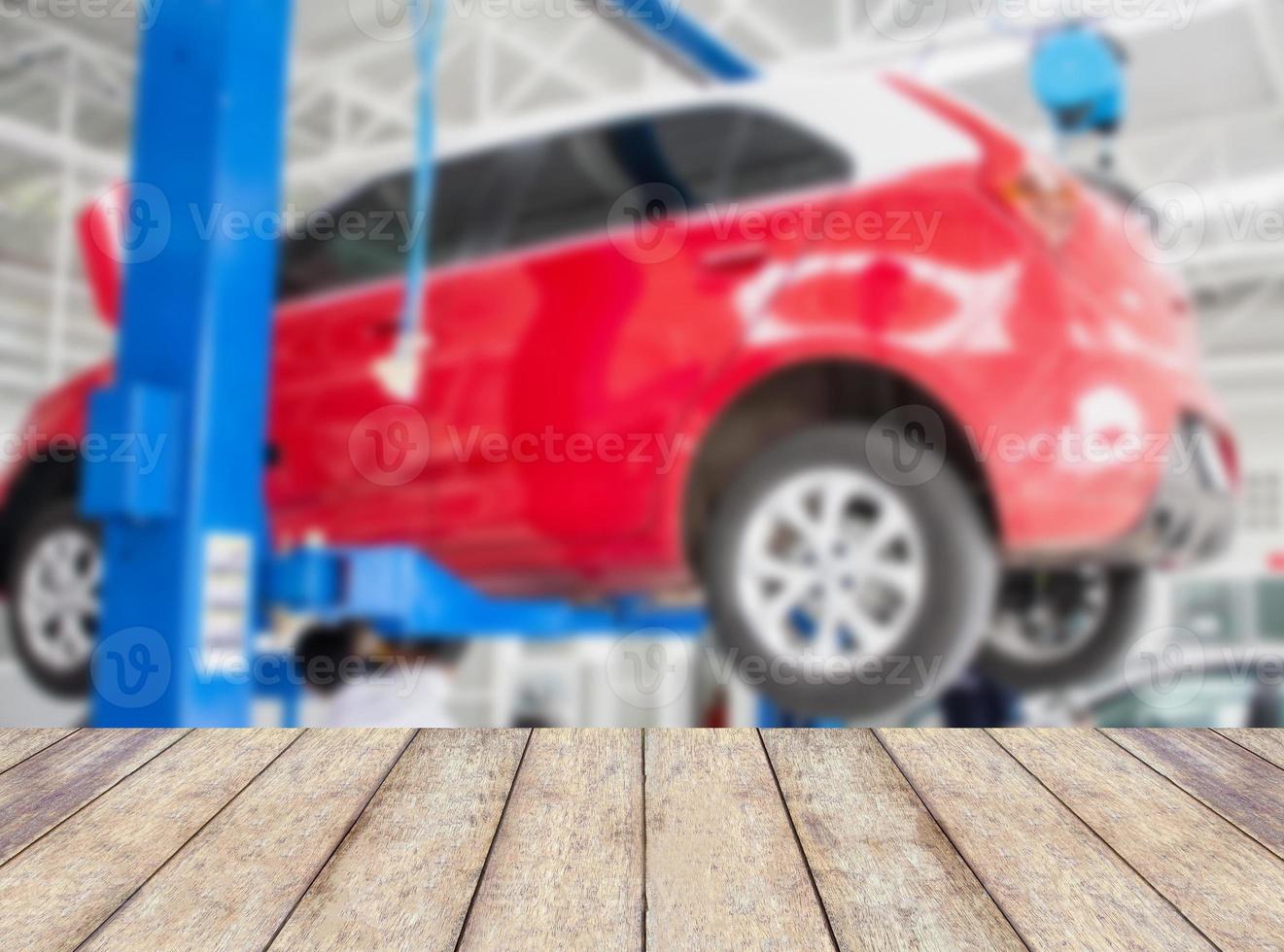 Wood table top with blur car service centre background photo
