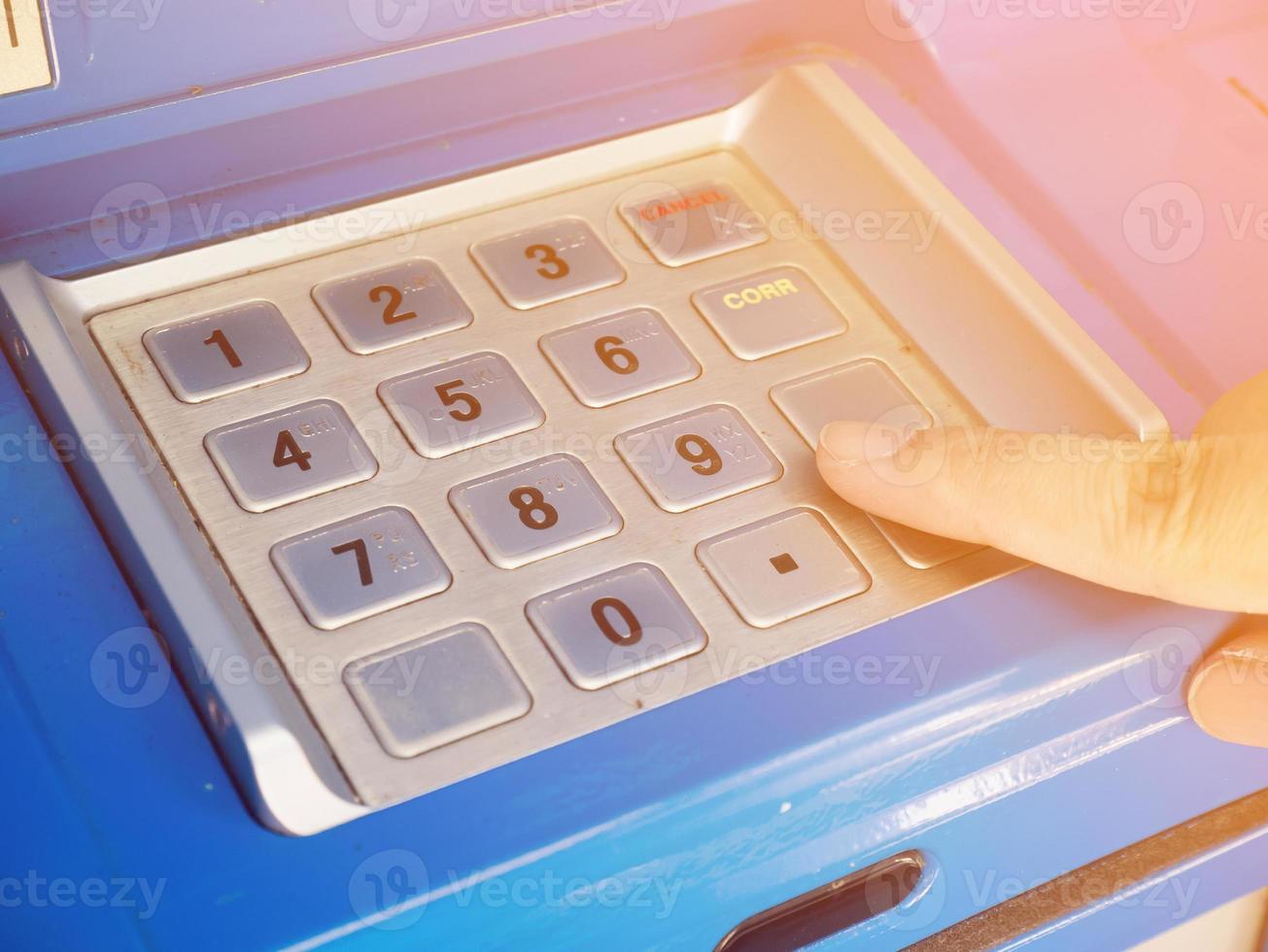 woman using ATM machine to withdraw money photo