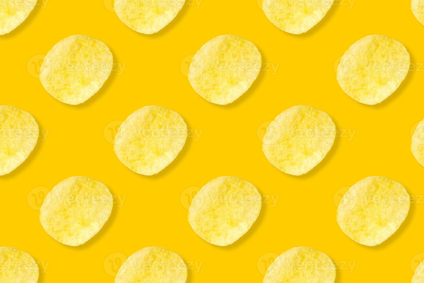 Potato chips pattern on pastel yellow background top view flat lay photo