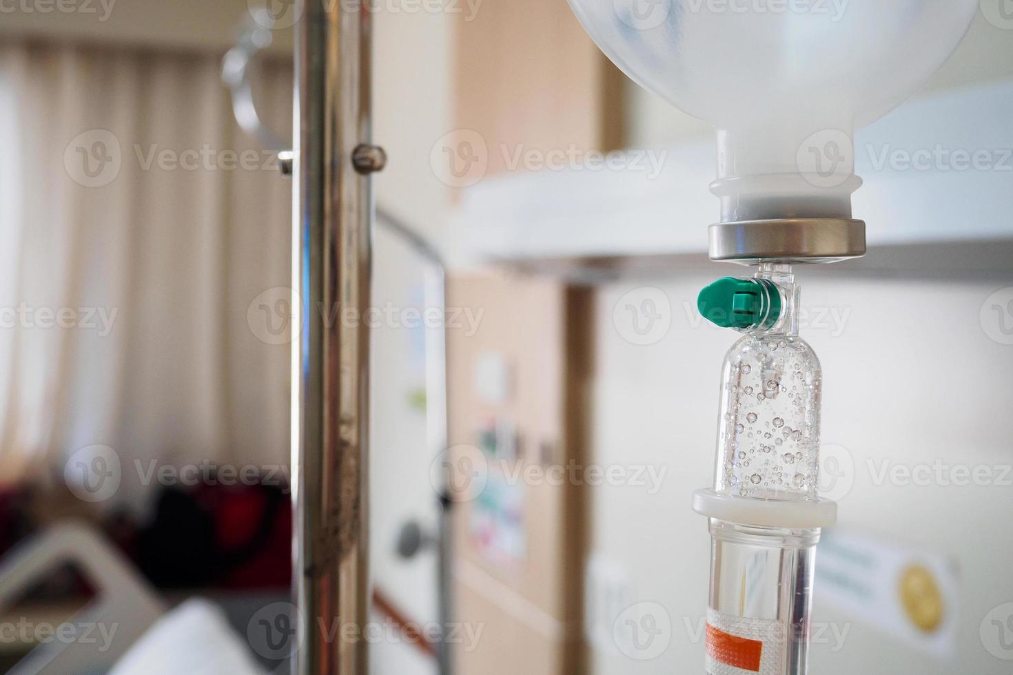 Medical drip with hospital blurred background photo