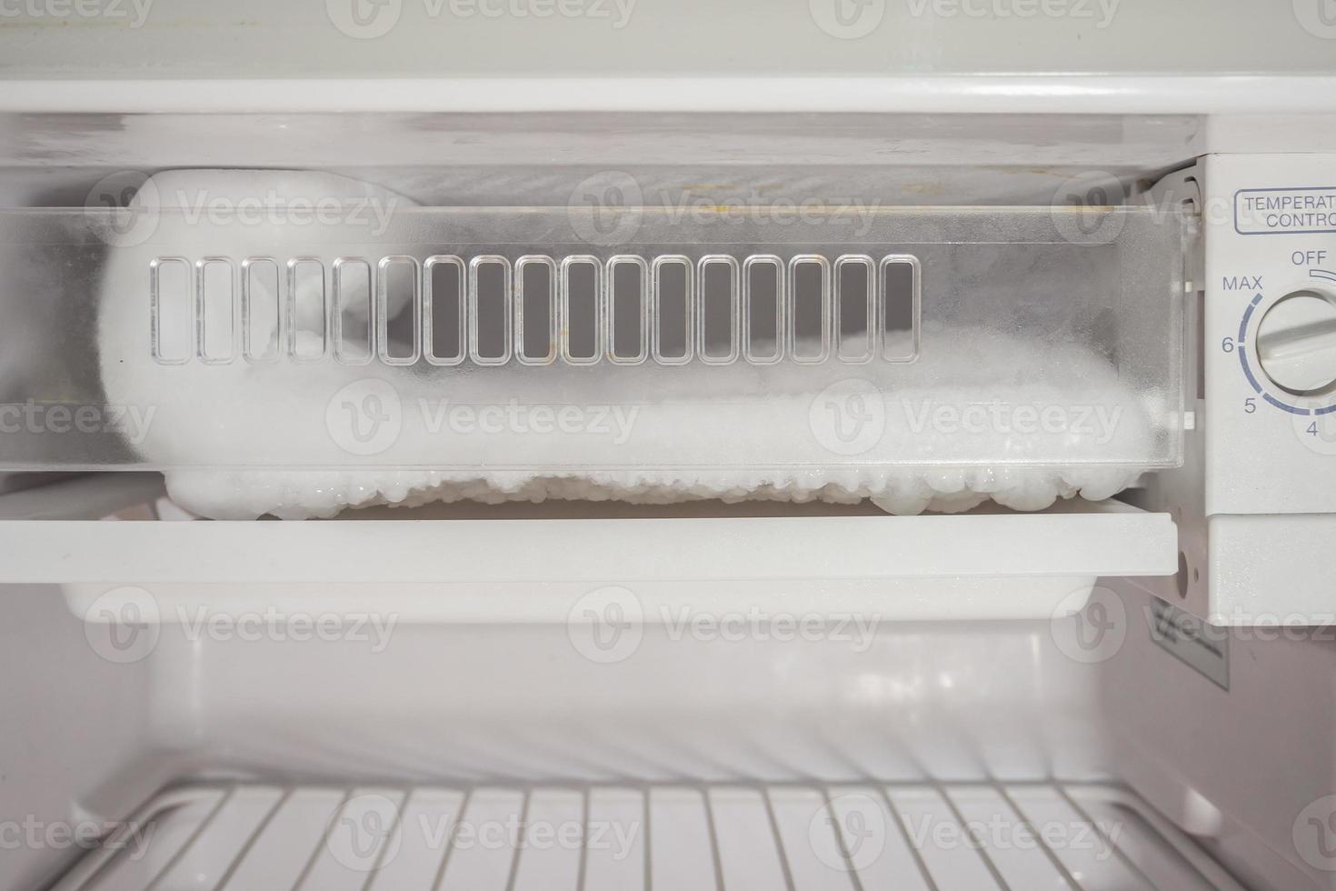 frozen Ice buildup in the freezer of refrigerator photo