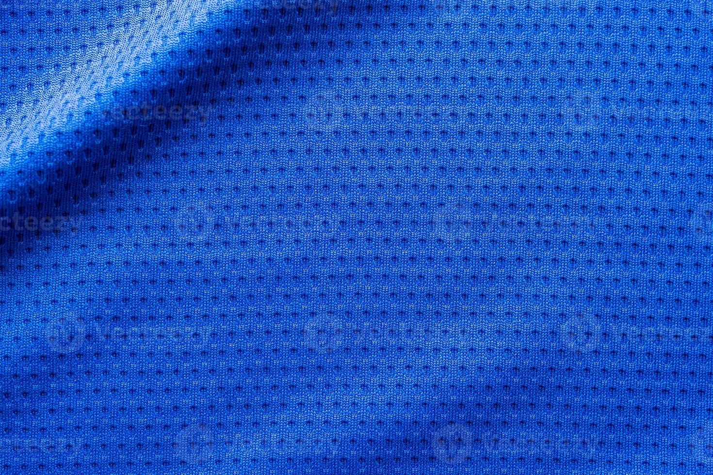 Blue color fabric sport clothing football jersey with air mesh texture background photo