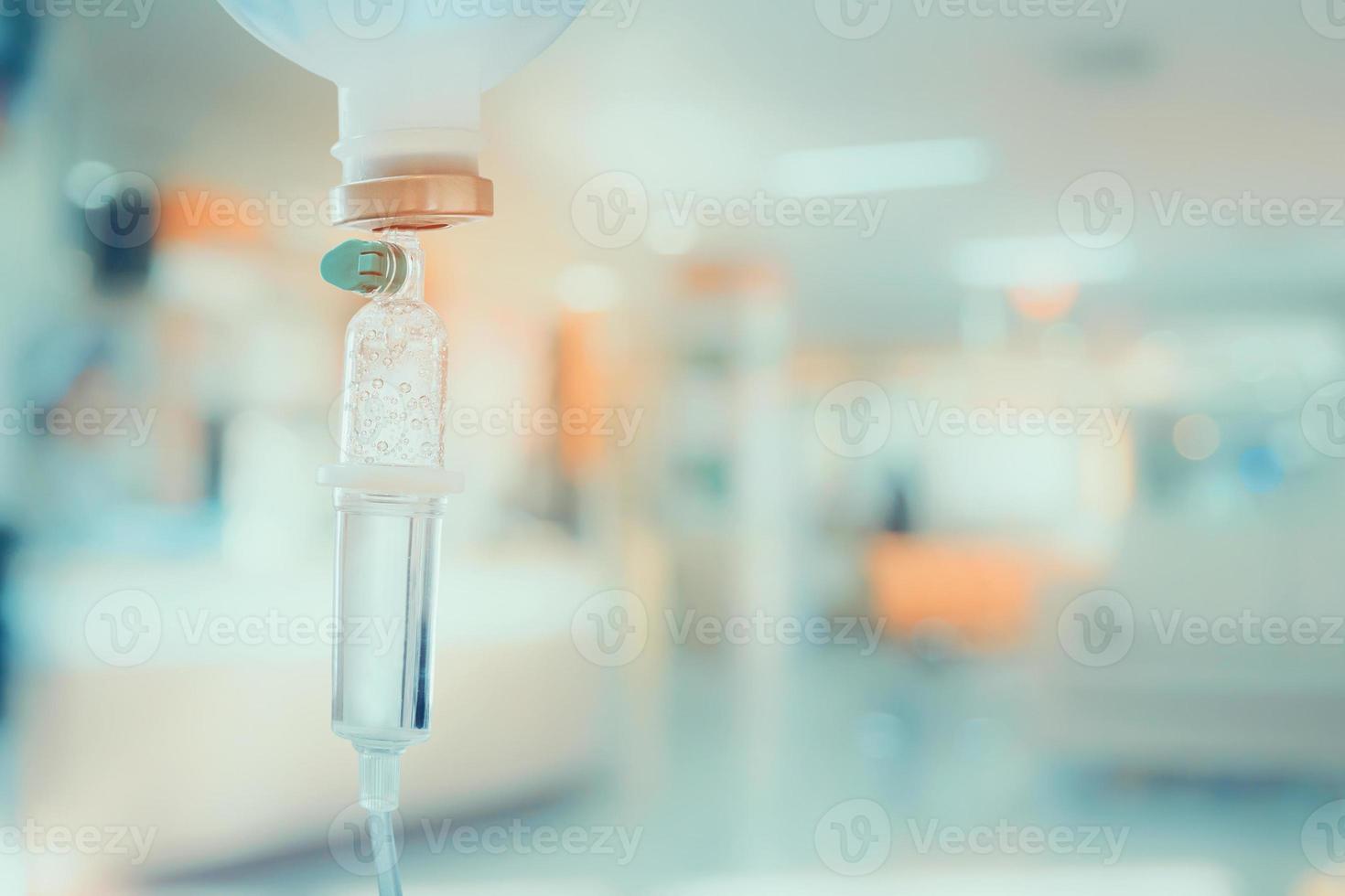 Medical drip with hospital blurred background photo