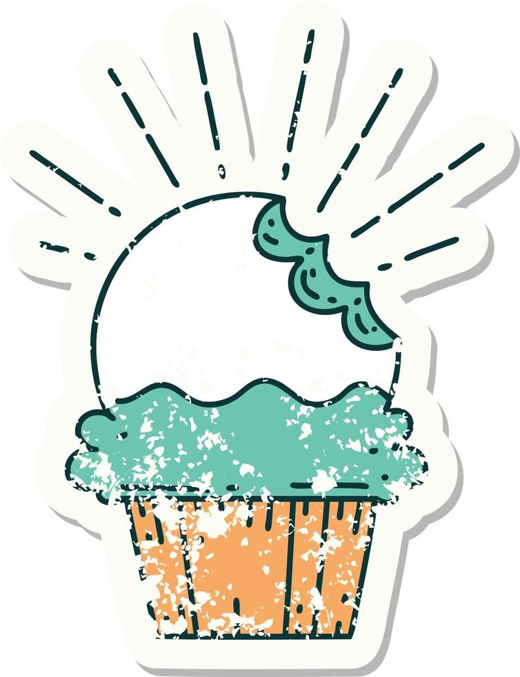 worn old sticker of a tattoo style cupcake with missing bite vector