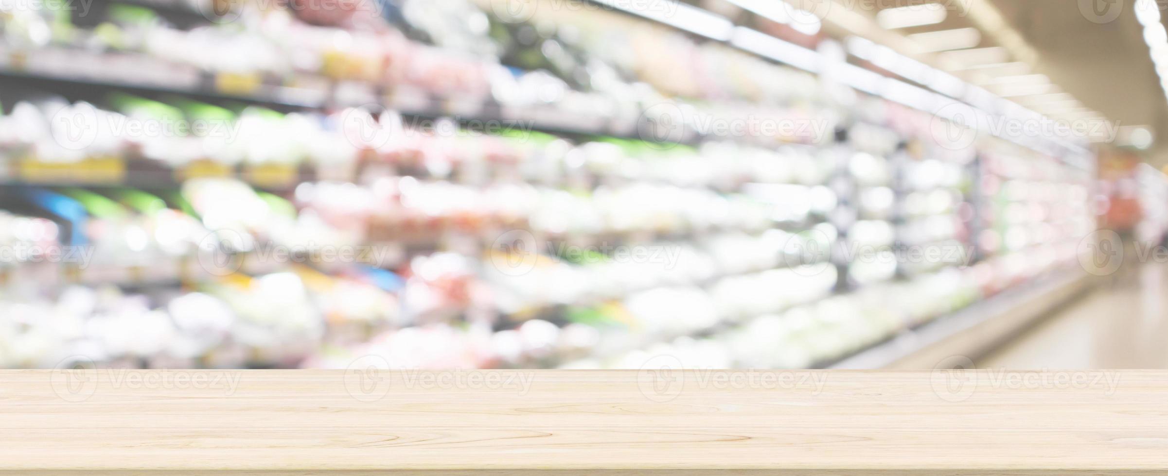 Wood table top with supermarket grocery store blurred defocused background with bokeh light photo