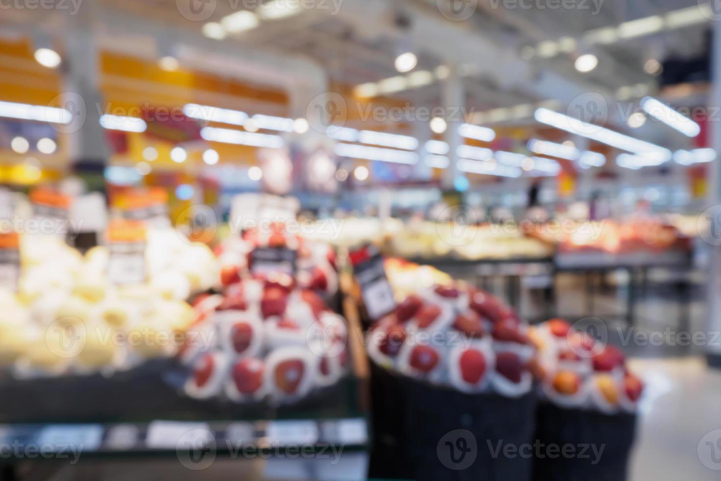 Grocery store with fresh fruits and vegetables shelves in supermarket blur background photo