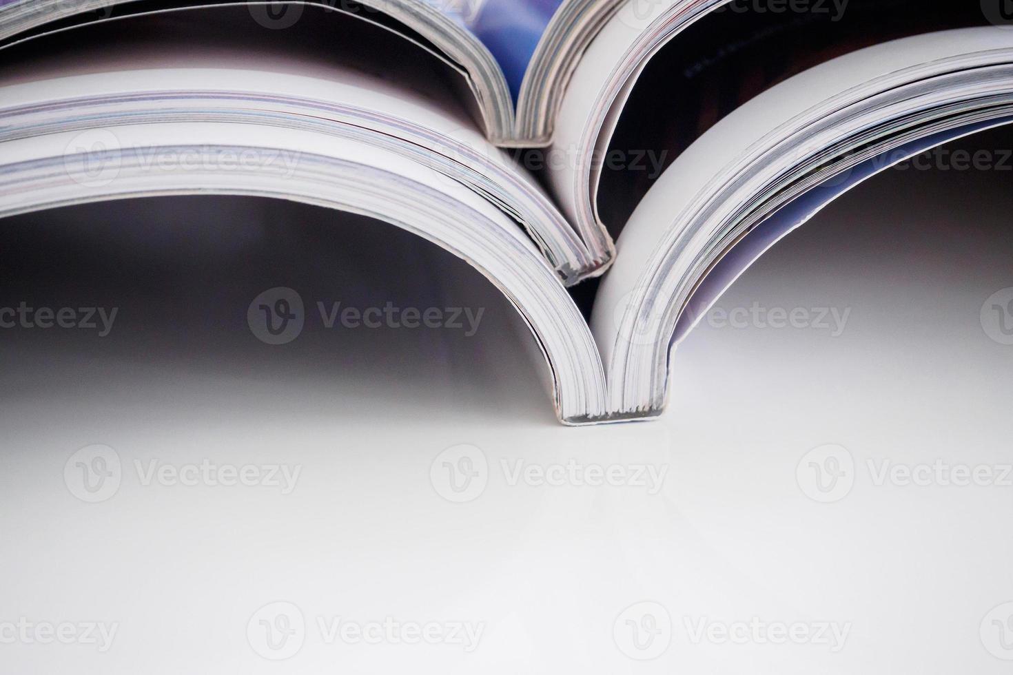 pile of magazines stack on white table in living room photo