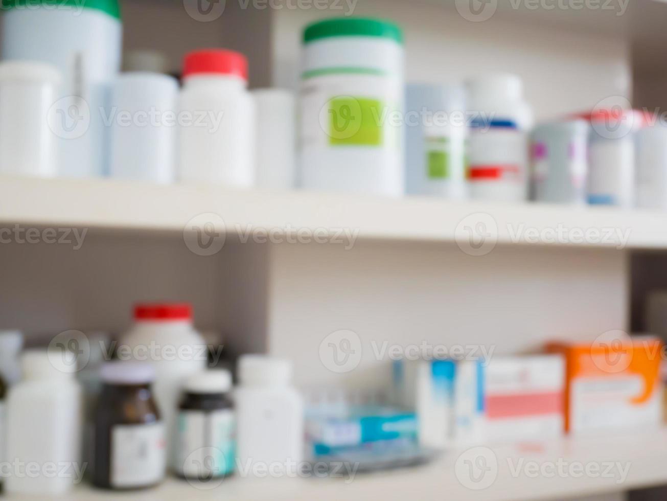Close up of medicine bottles on shelves of drugs in the pharmacy photo