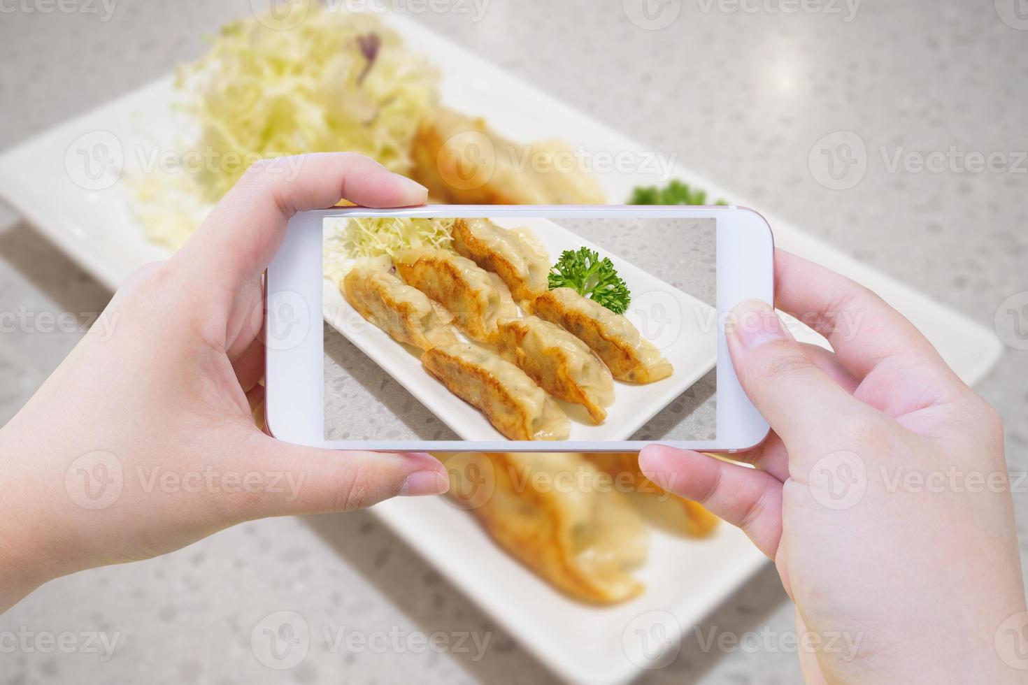 taking photo of Gyoza dumplings with smartphone