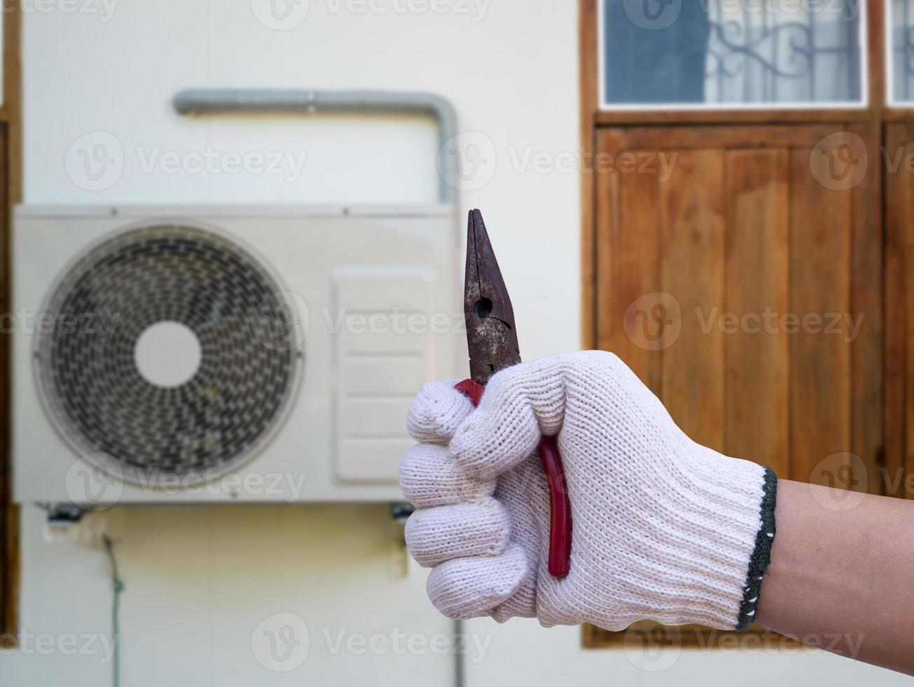 technician installing outdoor air conditioning unit photo