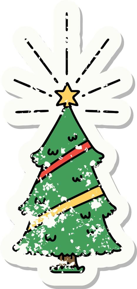 worn old sticker of a tattoo style christmas tree with star vector