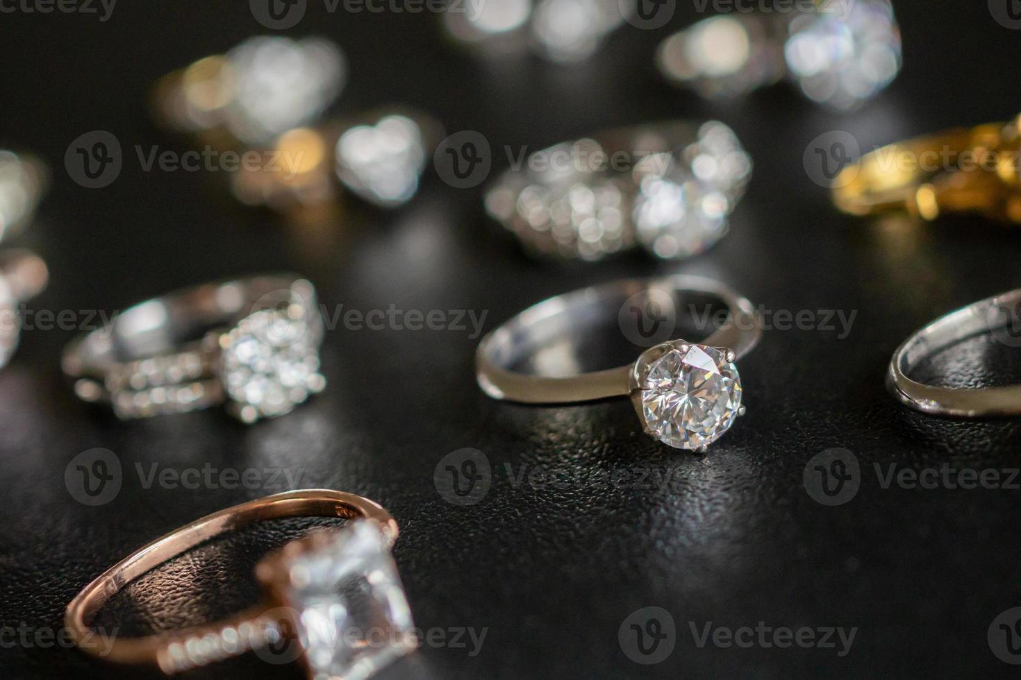 Jewelry diamond rings set on black background close up photo