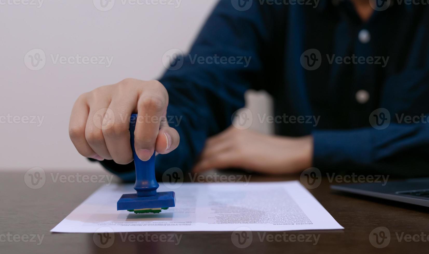 Professional businessperson notary stamp success on the document at desk, law or accounting confirmation concept. photo