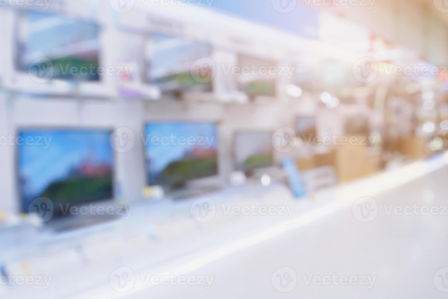 Television shelves retail shop display in Electronic Department store blurred background photo