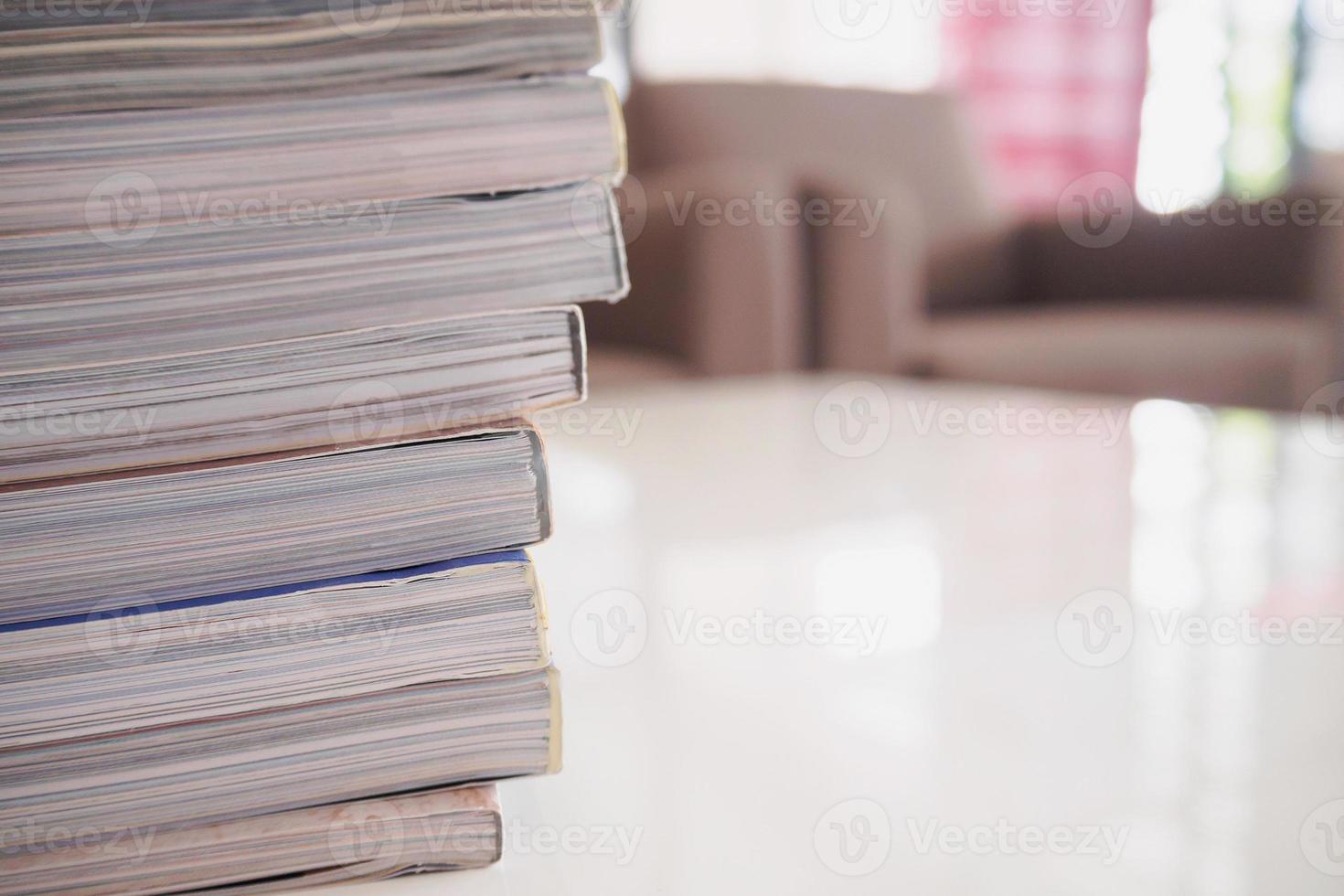 pile of magazines stack on white table in living room photo