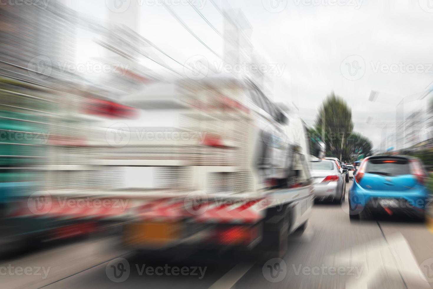 Broken car on tow truck after traffic accident, on the road service photo