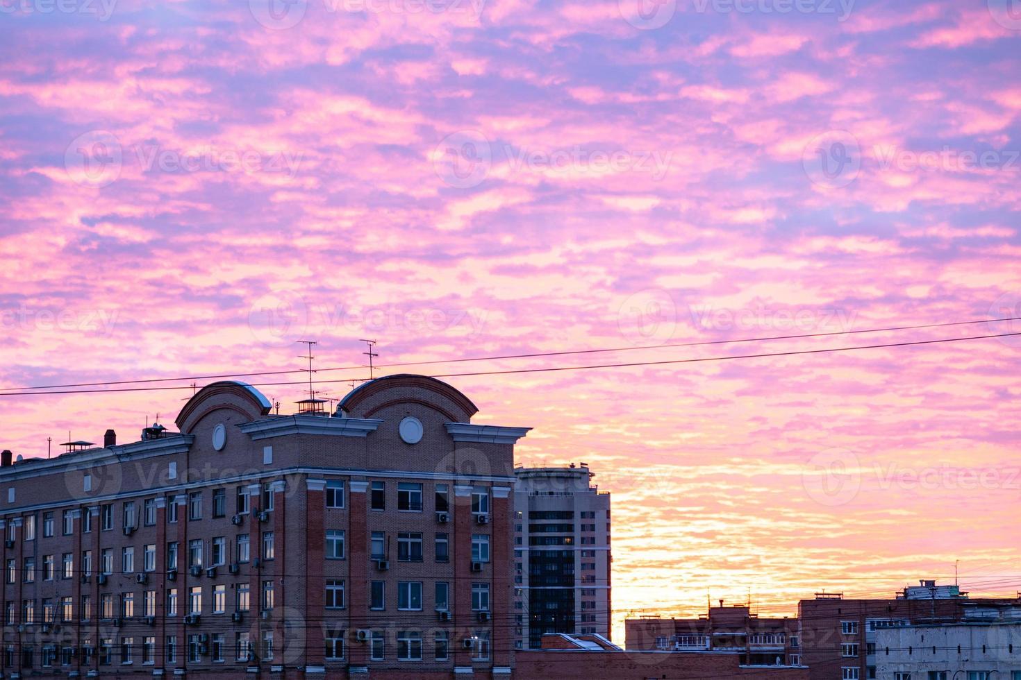 purple and yellow cloudscape over apartment houses photo