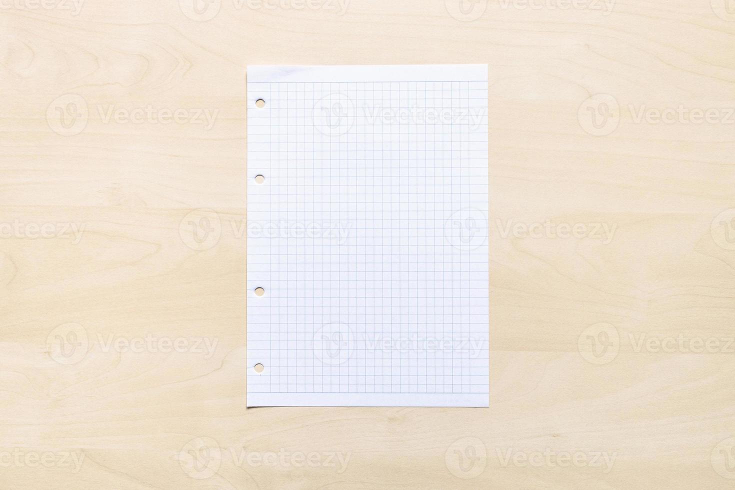 blank sheet of squared paper on light board photo
