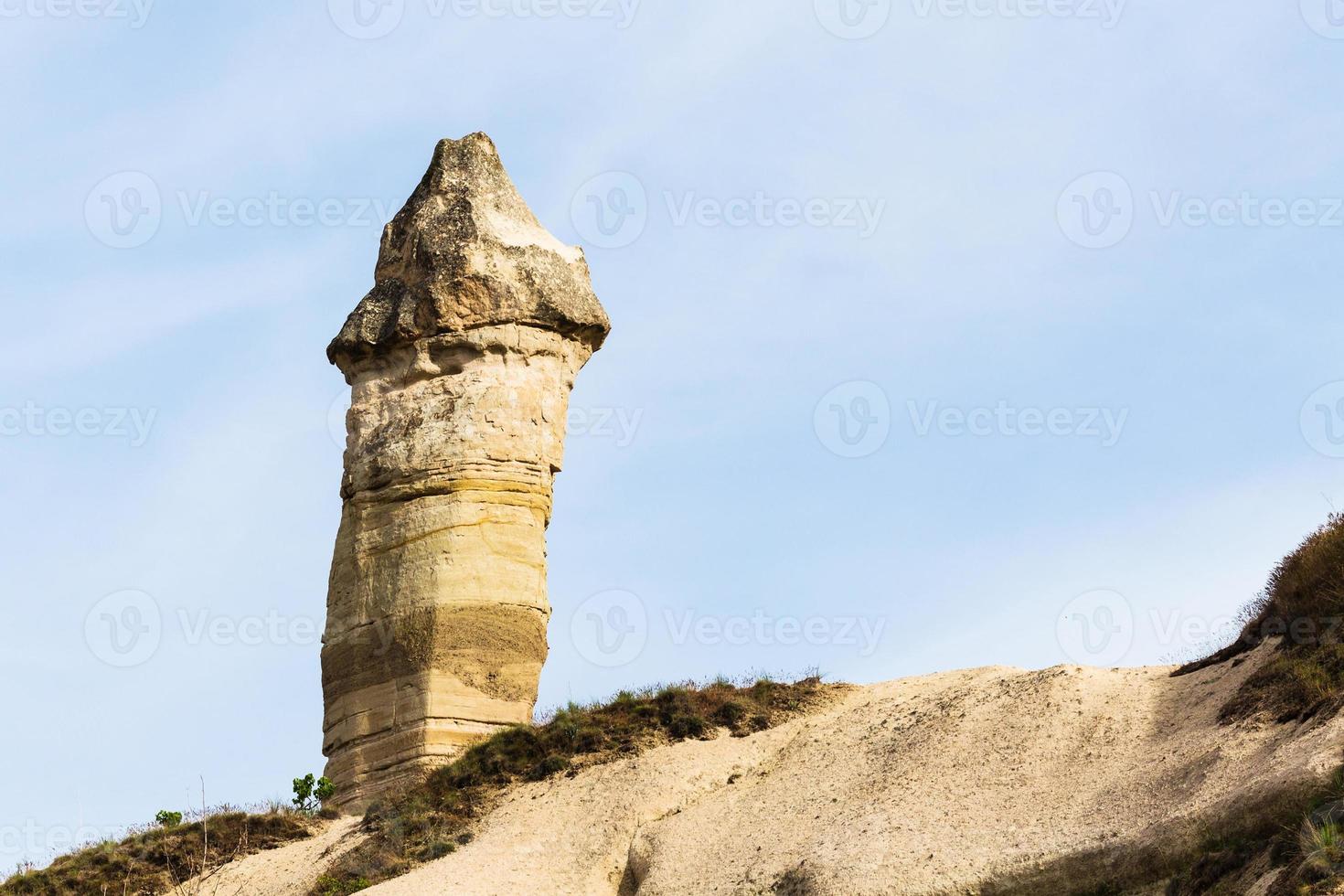 fairy chimney rock on mountain slope in Goreme photo
