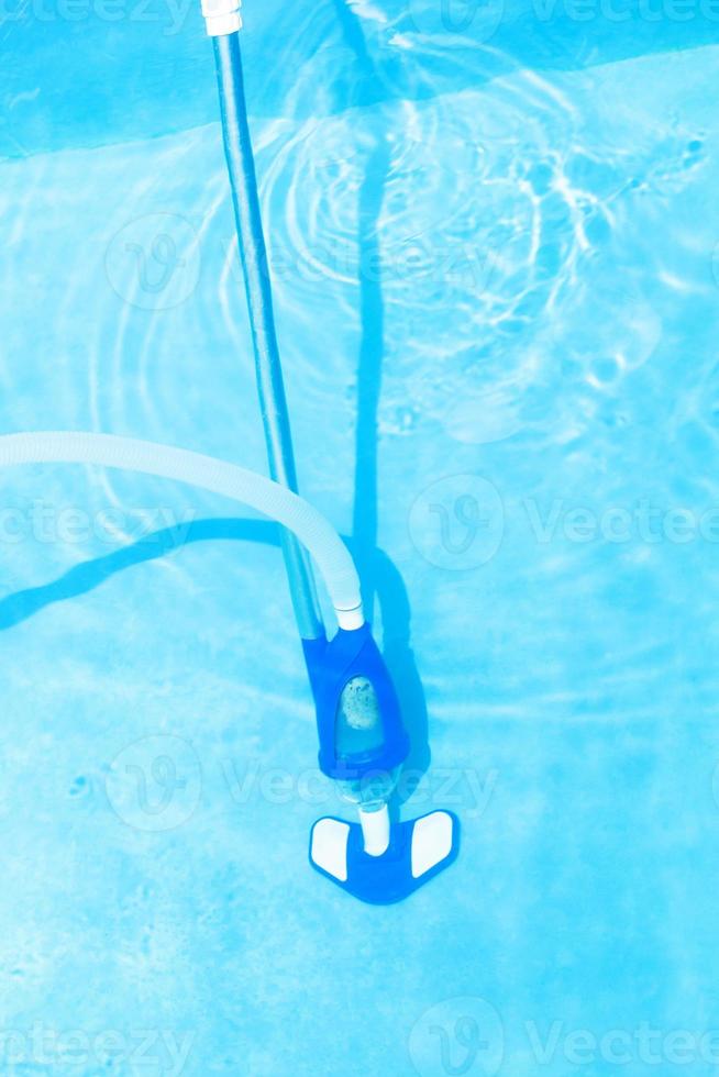 vacuum cleaning of swimming pool photo