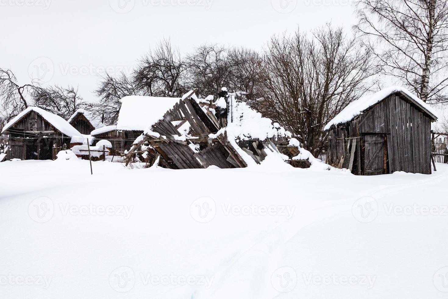 snow-covered old abandoned courtyard in village photo