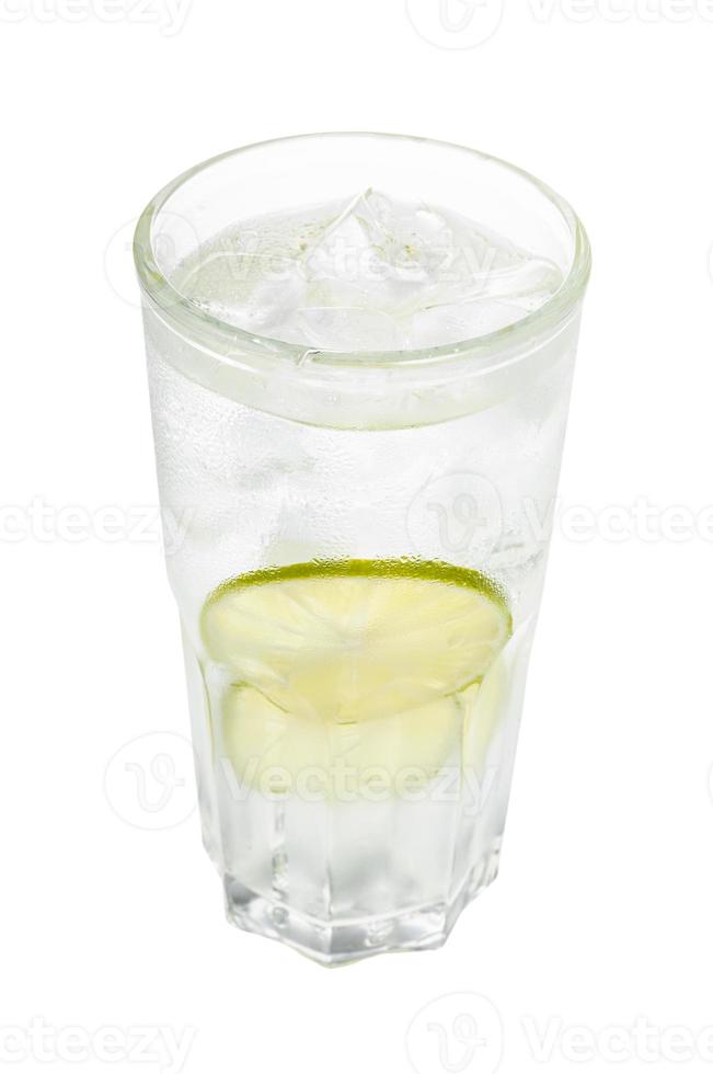 gin tonic cocktail in glass with ice and lime photo