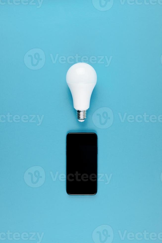 LED light bulbs and modern smartphone mockup photo