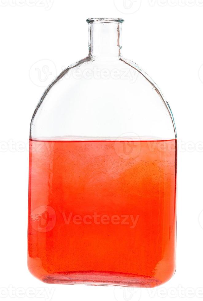 solución de tinta roja en agua en frasco de vidrio aislado foto
