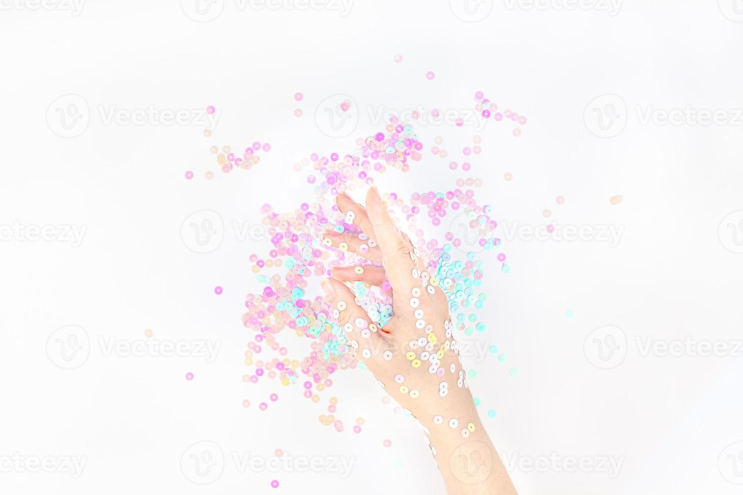 Pearl pastel confetti sparkles with woman hand photo