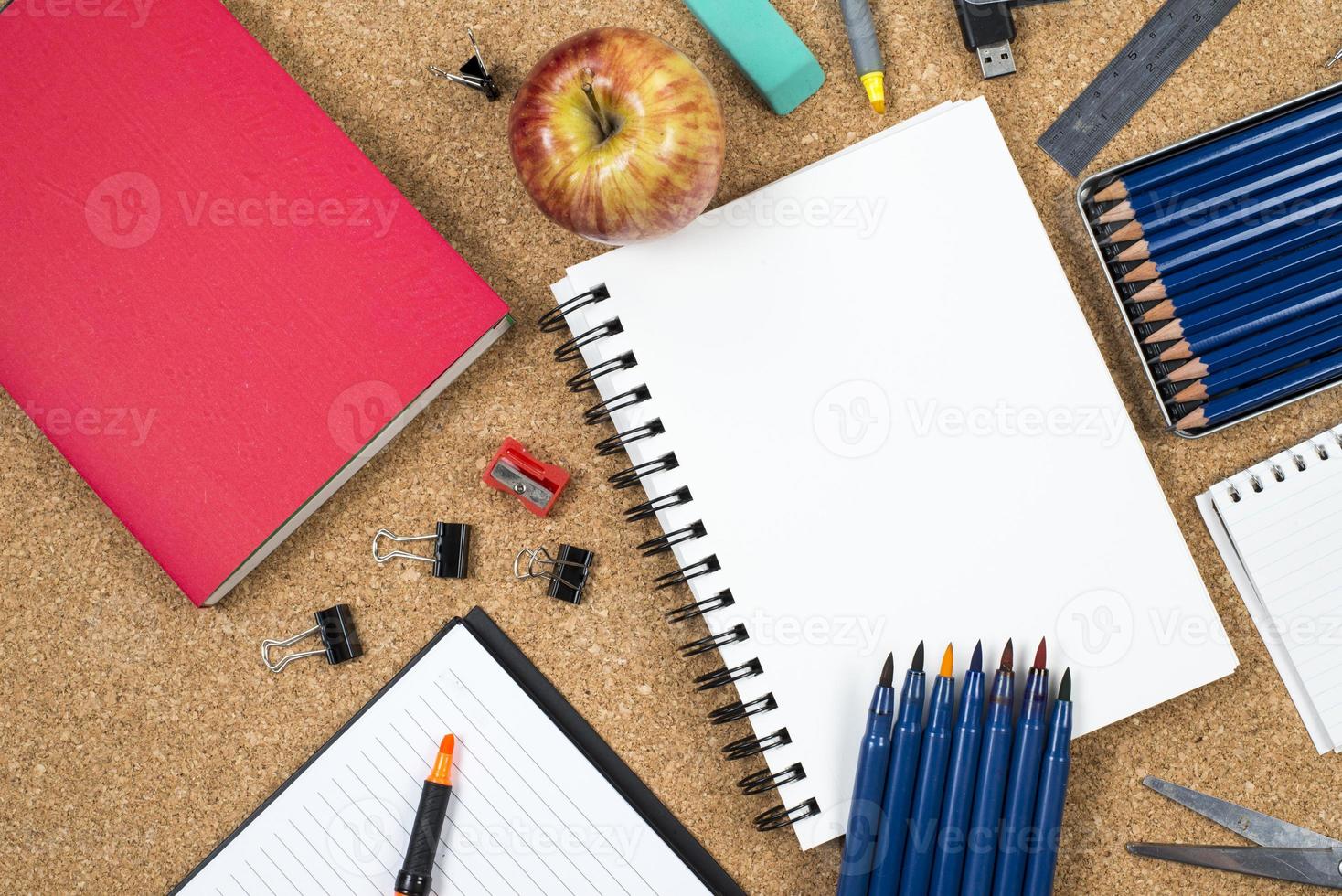 School elements on cork background with space for text symbolizing back to school photo