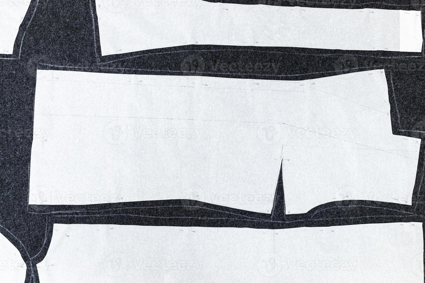 paper-layout-of-sewing-patterns-on-dark-fabric-11186001-stock-photo-at