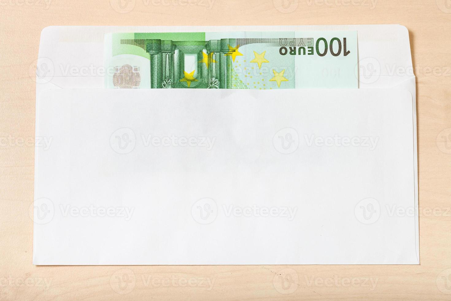 single one hundred euro note in envelope on table photo