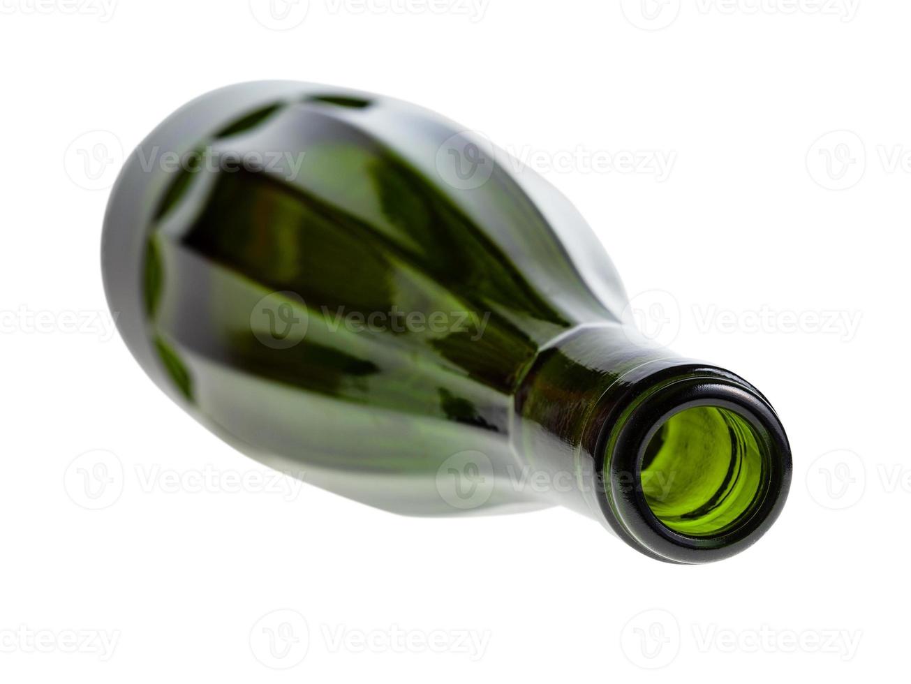 overturned faceted green wine bottle isolated photo