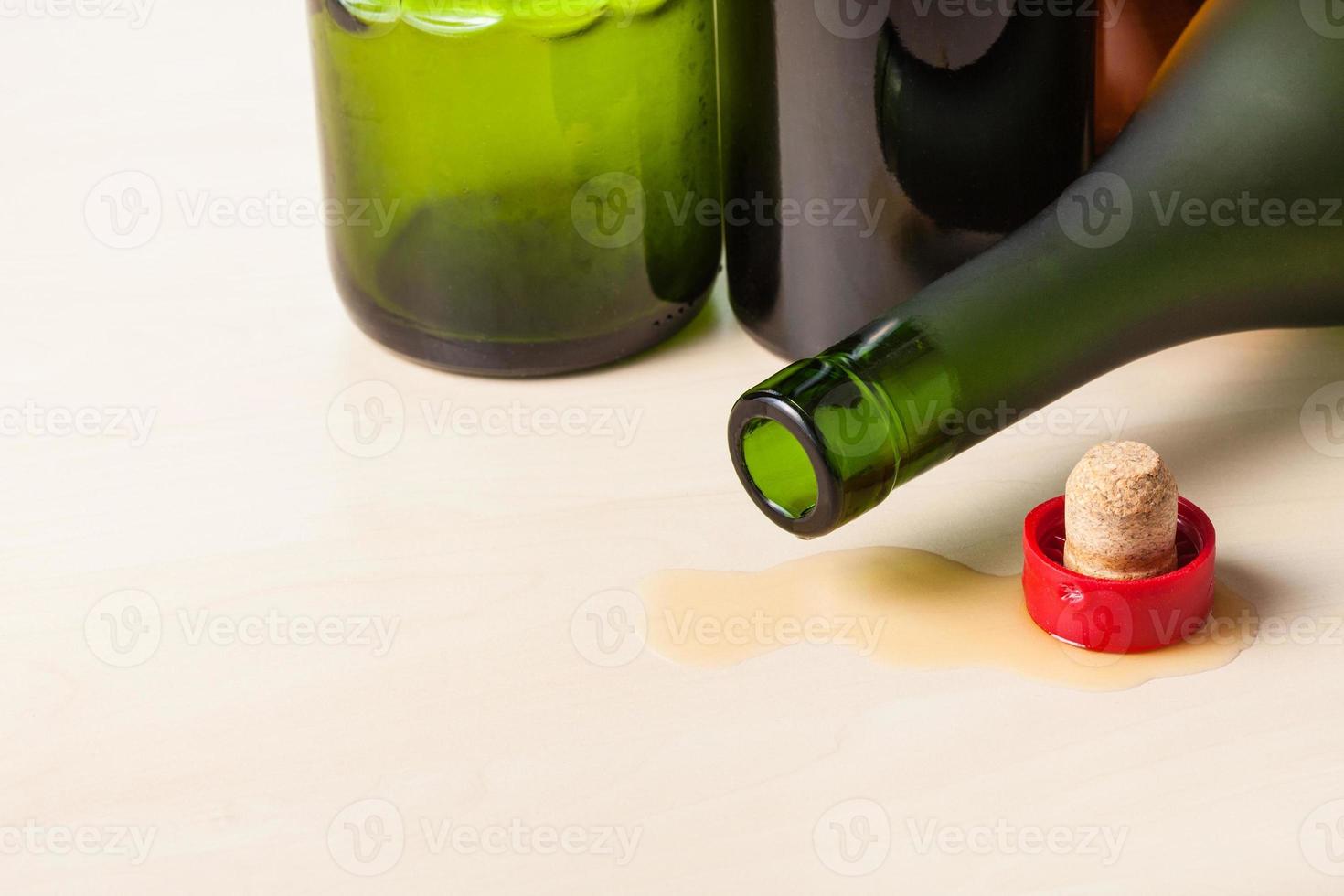 empty wine bottles and cork on wooden board photo