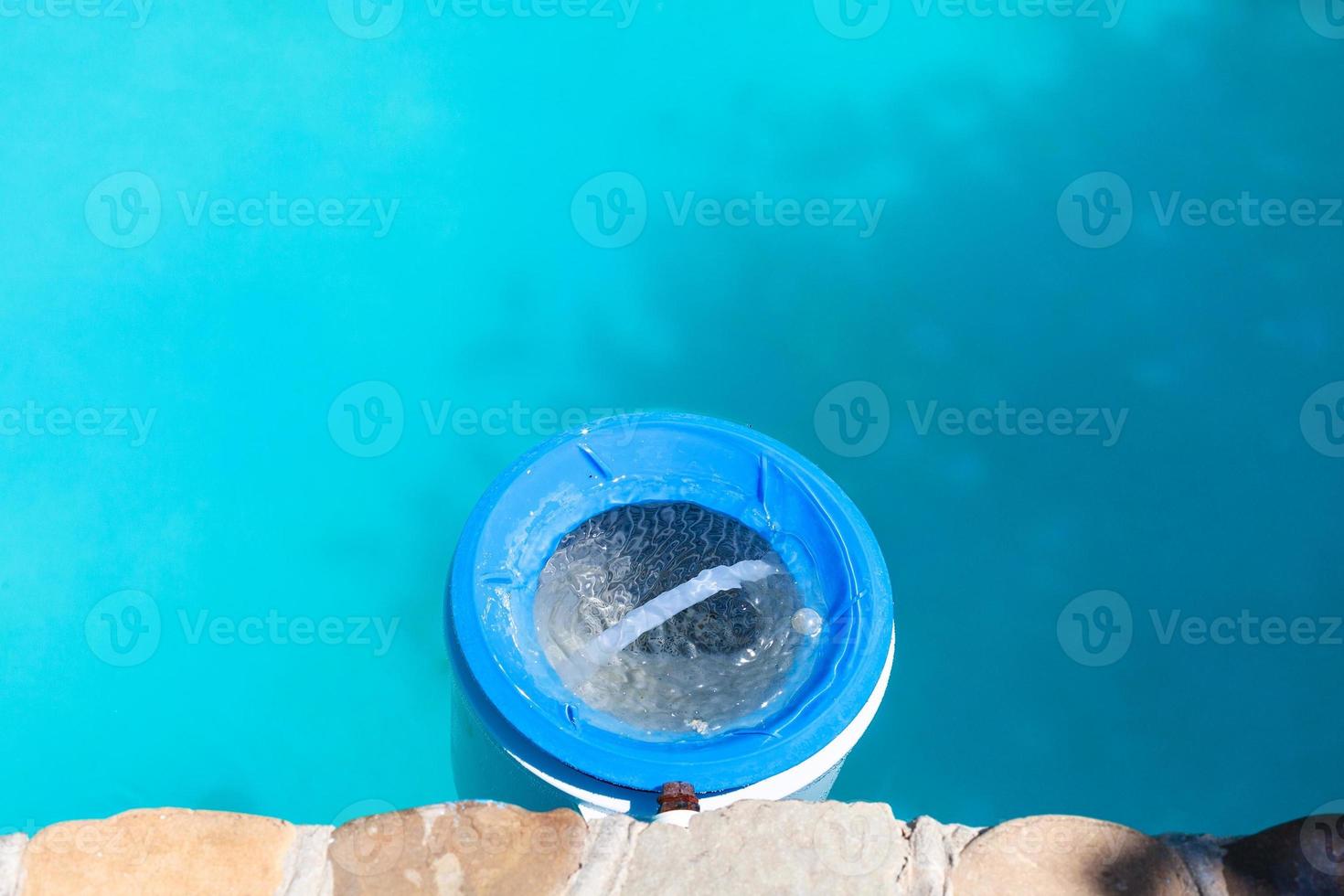 plastic water filter near wall of swimming pool photo