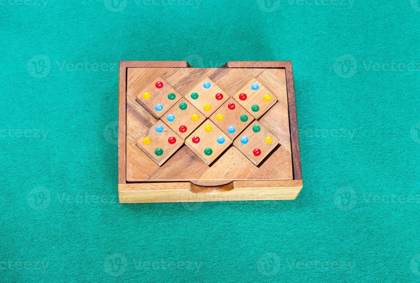 wooden box with puzzle on green table photo