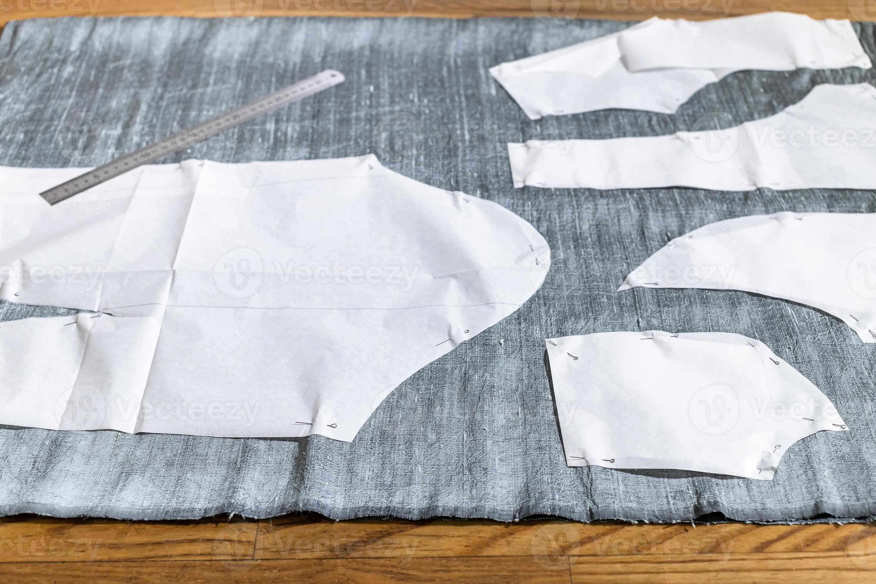 paper sewing pattern layouts on gray fabric 11186511 Stock Photo at ...