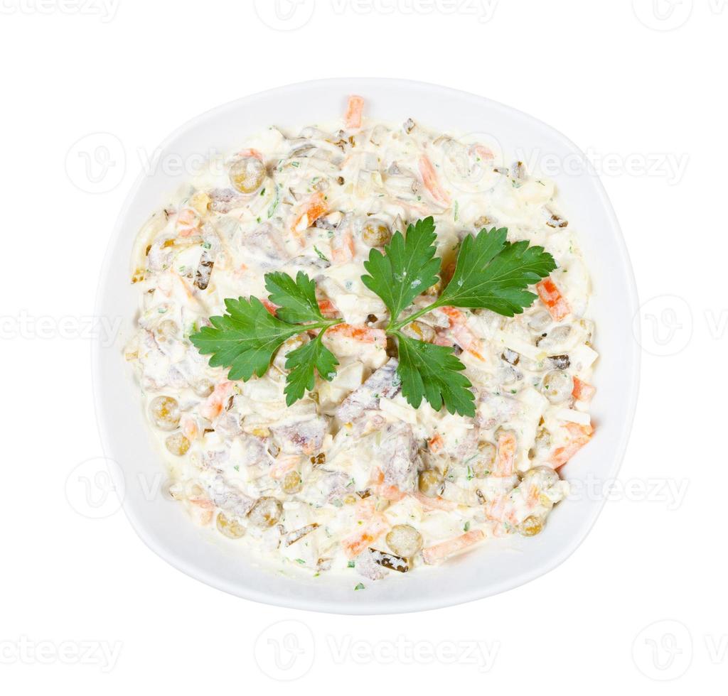 portion of Olivier salad with leaf of parsley photo