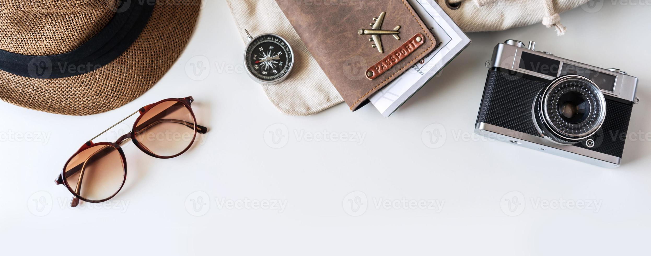 Retro camera with travel accessories and items on white background with copy space, Travel concept, Top view photo