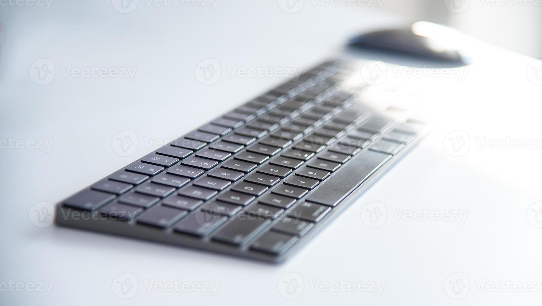 Modern working space with notepad, keyboard, computer or notbook  and pencils on white table in modern office, the working accessories for business man or designer photo