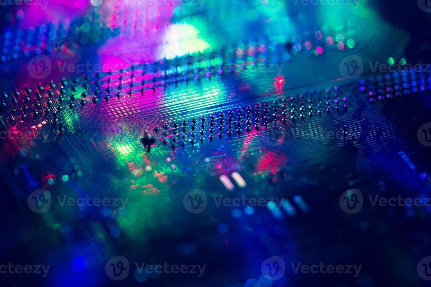 Abstract background with neon light on computer processing equipment photo