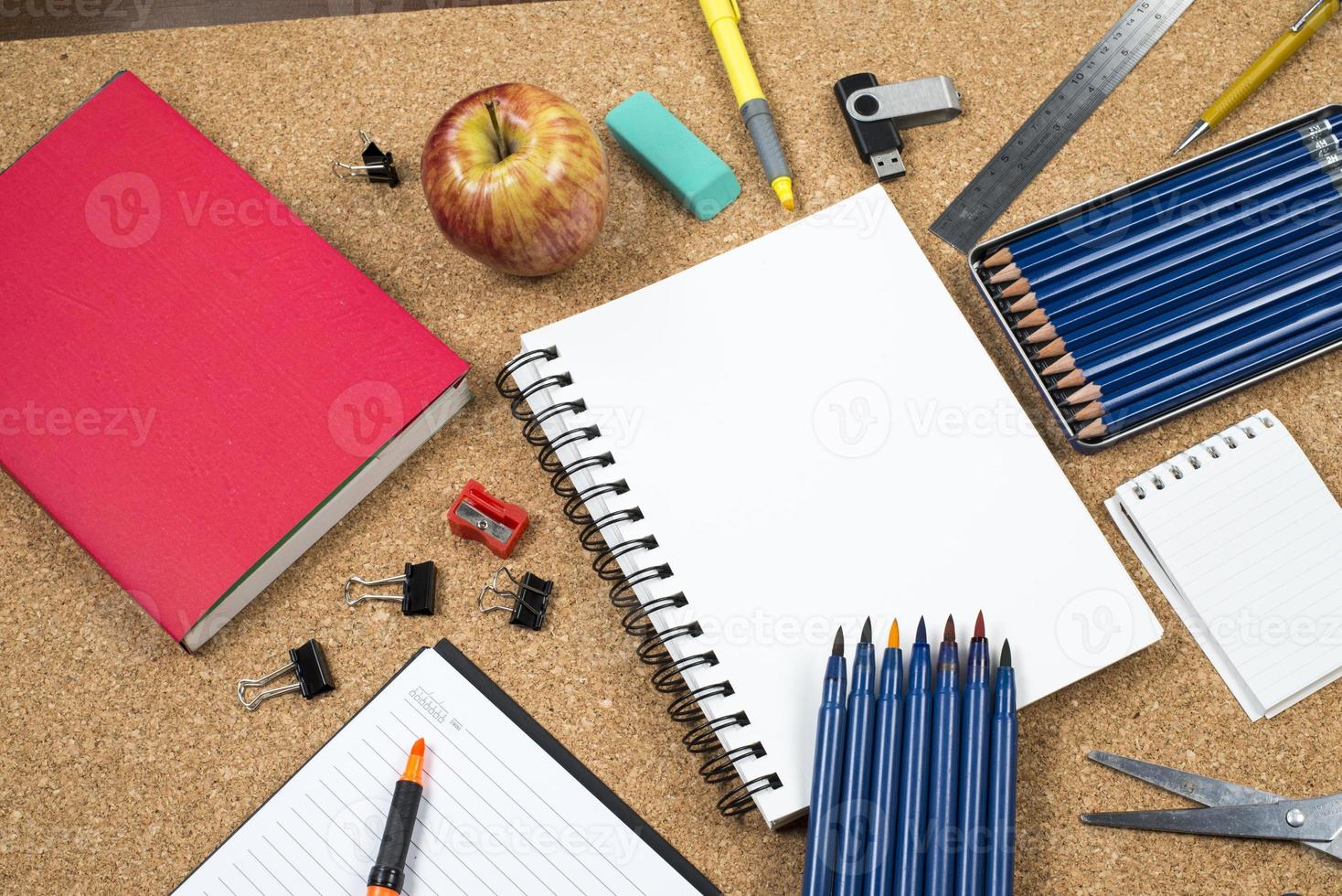 School elements on cork background with space for text symbolizing back to school photo