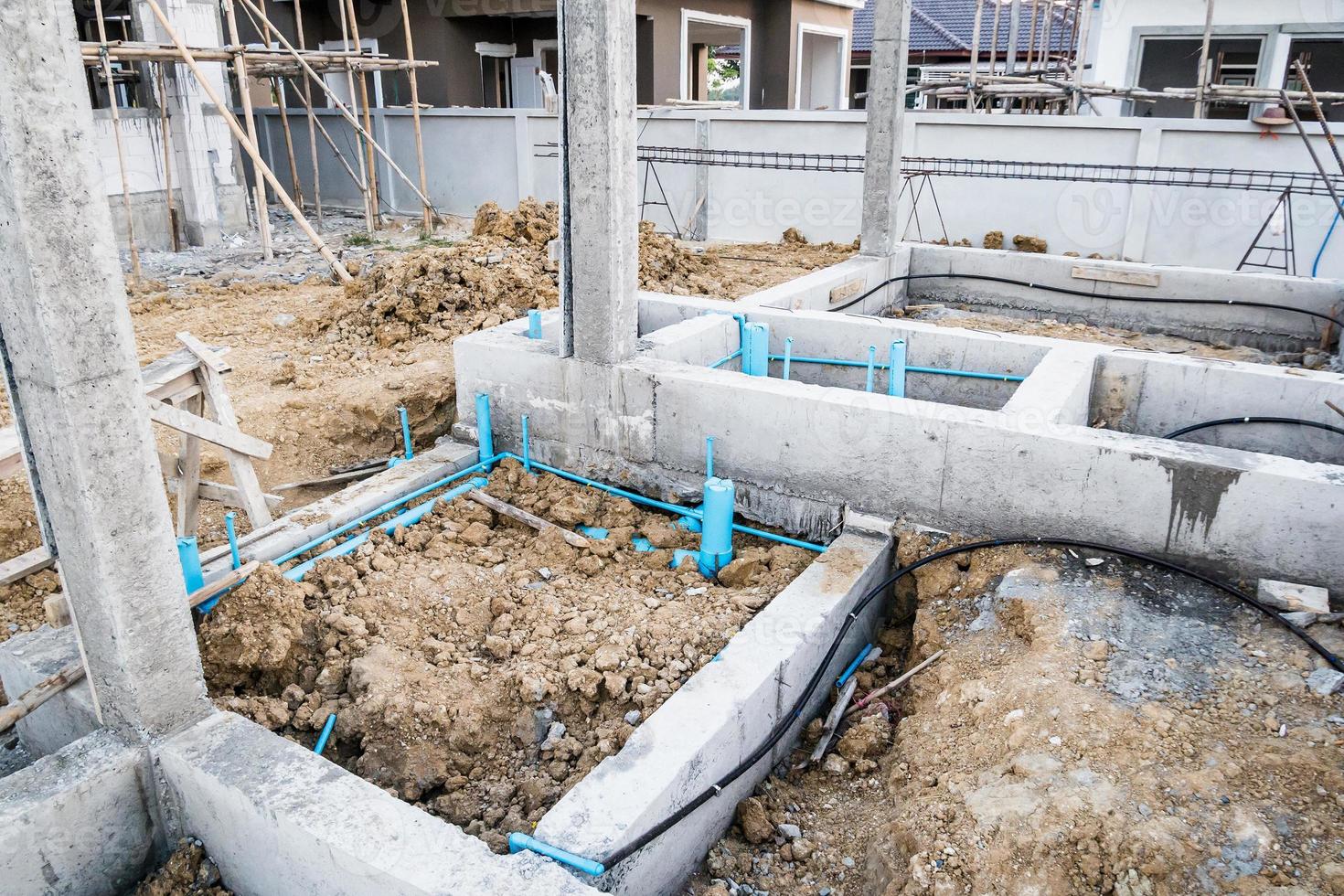 Pest control pipe system install at new house construction foundation for termite protection photo