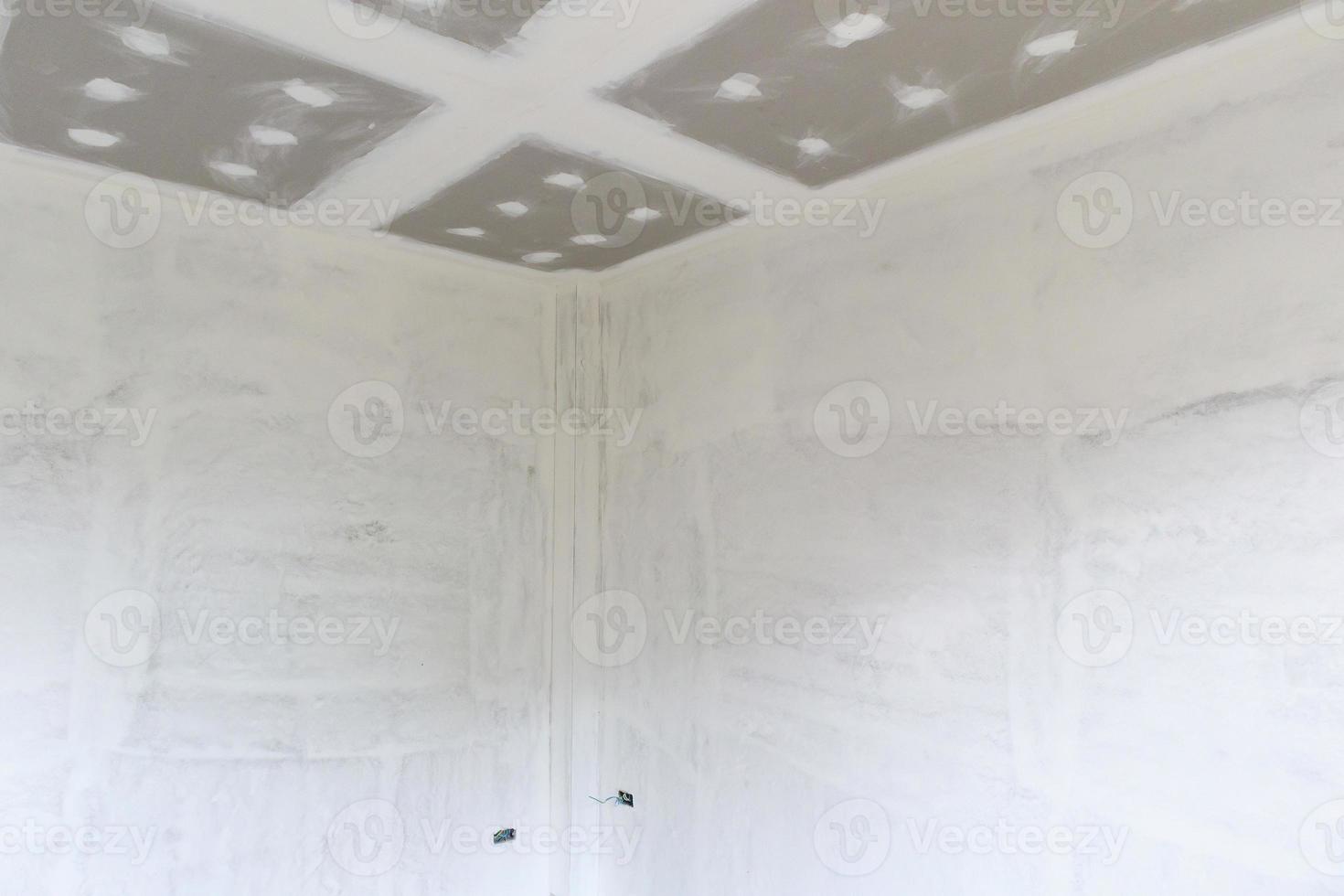 Empty room interior with gypsum board ceiling at construction site photo