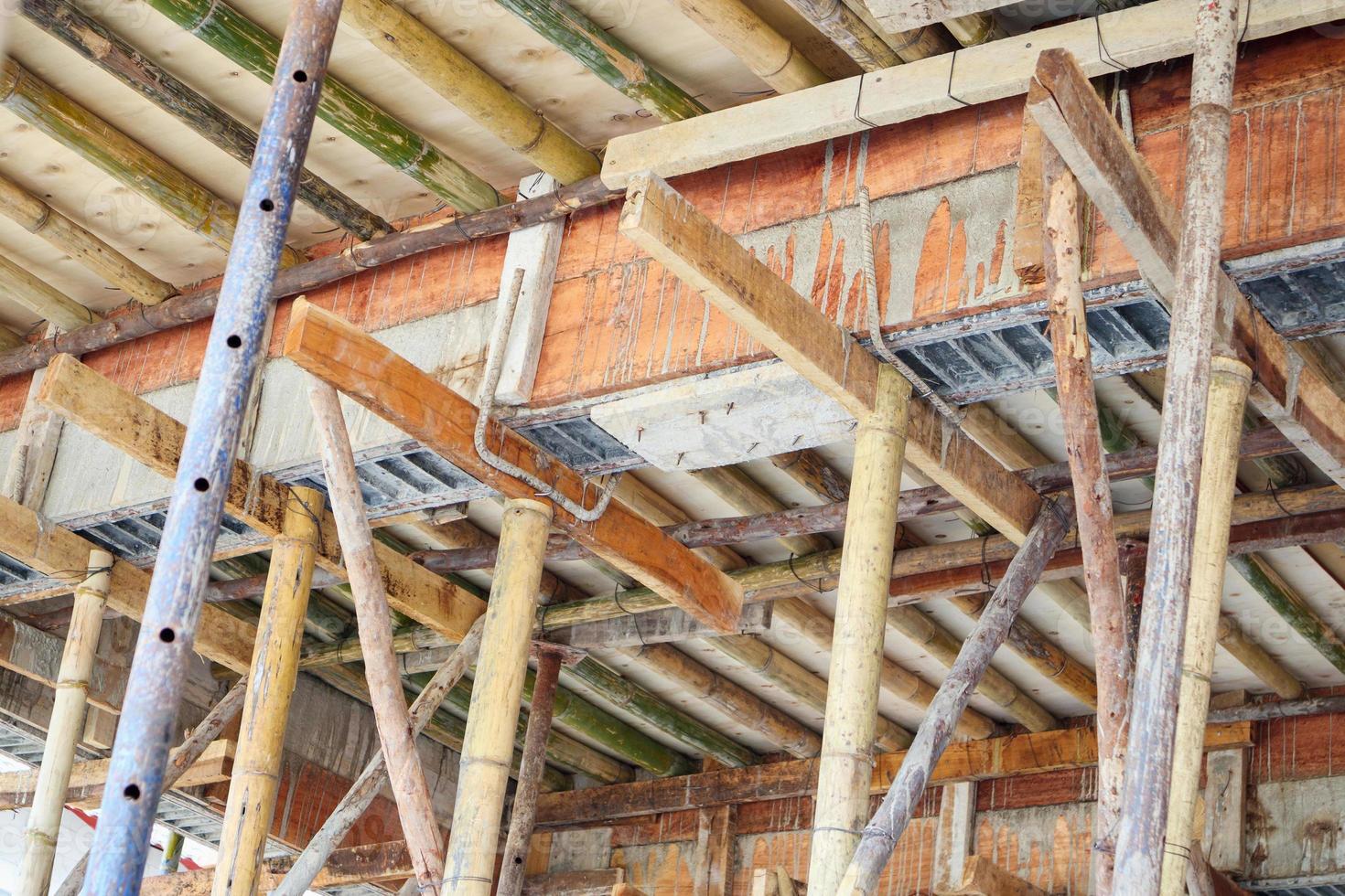 Bamboo scaffolding support concrete beam at house construction site photo
