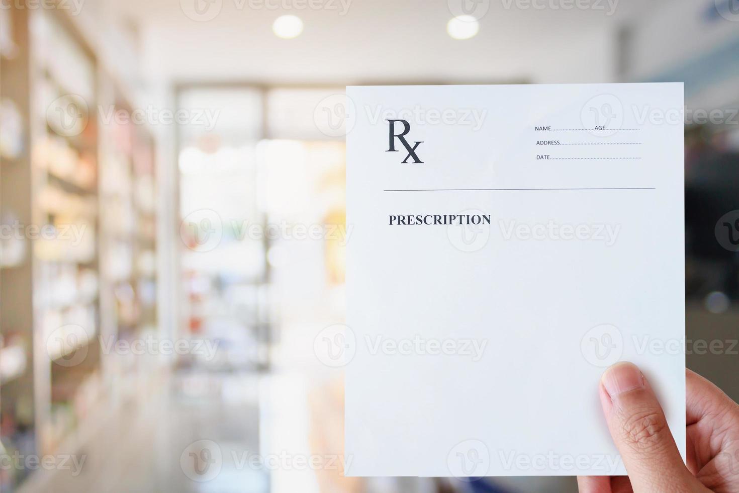 Pharmacist hold blank prescription in pharmacy store photo